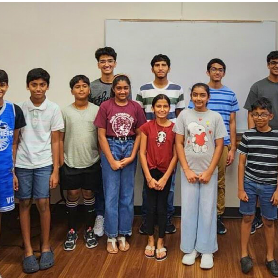Melbourne Math Circle participants standing together in front of a whiteboard